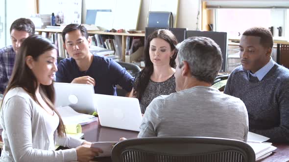 Architects Sitting Around Table Having Meeting 7