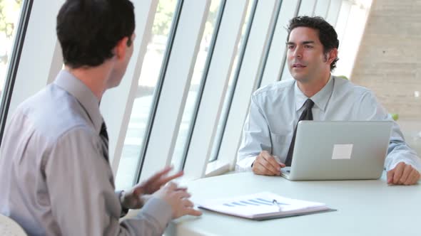 Two Businessmen With Laptop Having Meeting 2