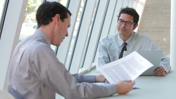Two Businessmen With Laptop Having Meeting 3 alt