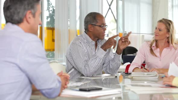 Team Meeting Around Table In Creative Office 3