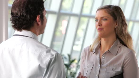 Businessman And Businesswoman Talking In Office 2 alt