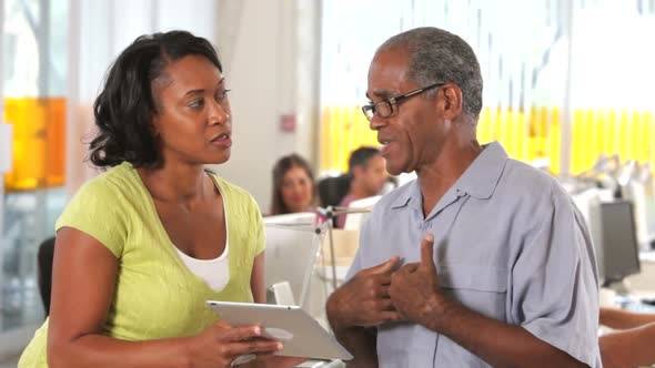 Man And Woman With Digital Tablet In Office