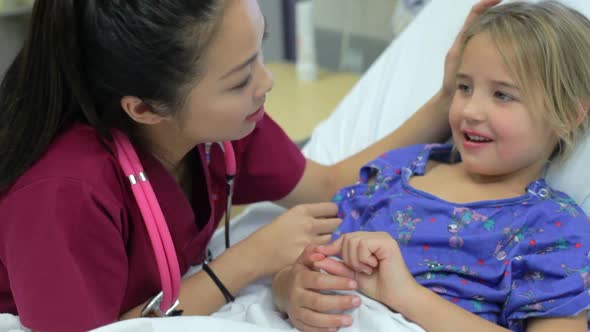Young Girl Talking To Female Nurse In Intensive Care Unit 1
