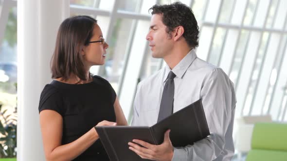 Businessman And Businesswomen Discussing Document 4