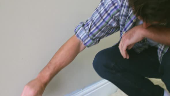 Man Decorating Room Using Paintbrush