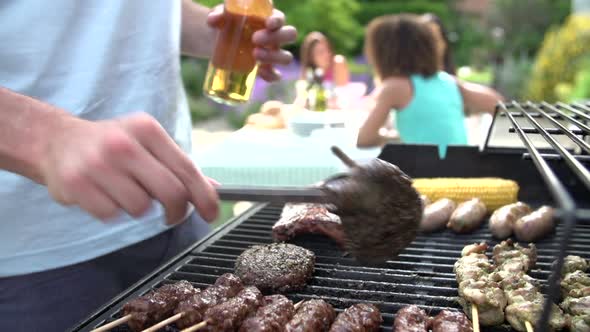 Man Cooking On Barbeque At Home