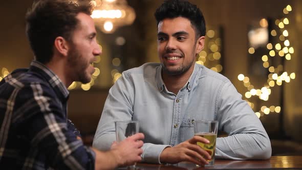 Two Male Friends Enjoying Evening Drinks In Bar 1