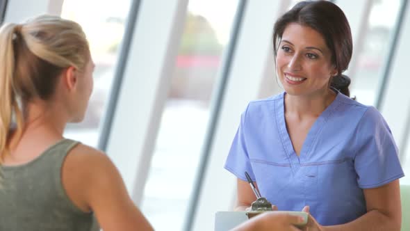 Nurse Taking Notes Froom Teenage Female Patient alt
