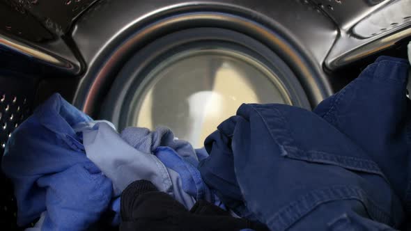 Man Putting Laundry Into Washing Machine 4