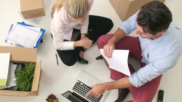 Overhead View Of Businesspeople Working At Laptop 1