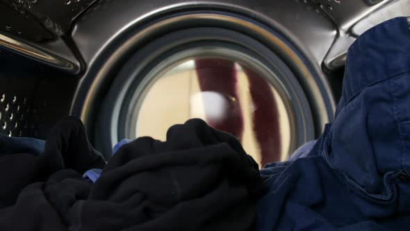 Woman Putting Laundry Into Washing Machine 1