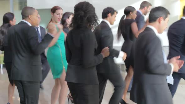 Businessmen And Businesswomen Dancing In Office Lobby 2 alt