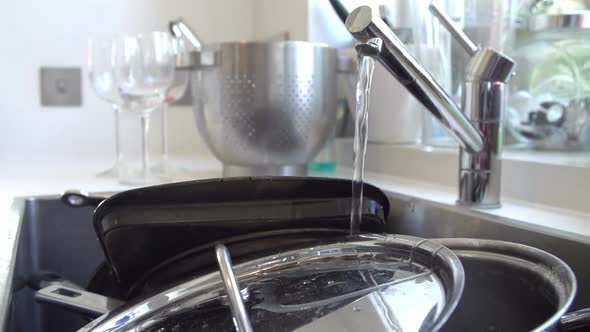 Water Running Over Pans In Sink