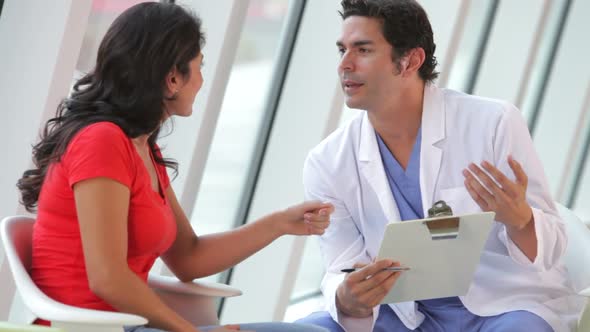 Doctor Discussing Notes With Female Patient