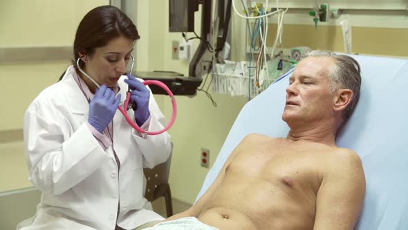 Doctor Examining Mature Male Patient In Hospital Bed 2
