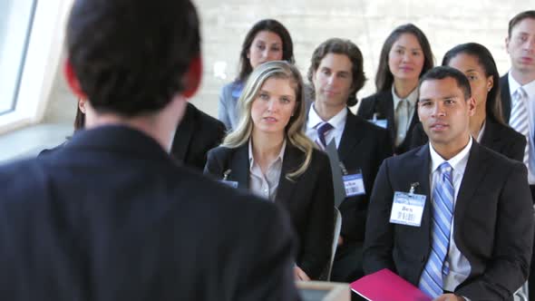 Businesspeople Listening To Speaker At Conference 3