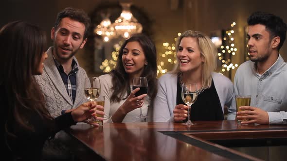 Group Of Friends Enjoying Evening Drinks In Bar 1 alt