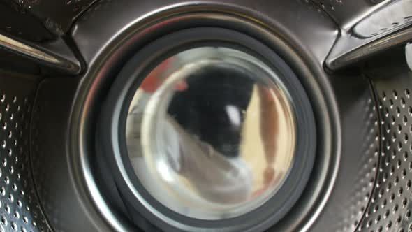 Man Taking Laundry Out Of Washing Machine