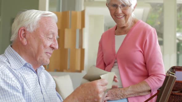 Senior Couple Reading Letter From Keepsake Box