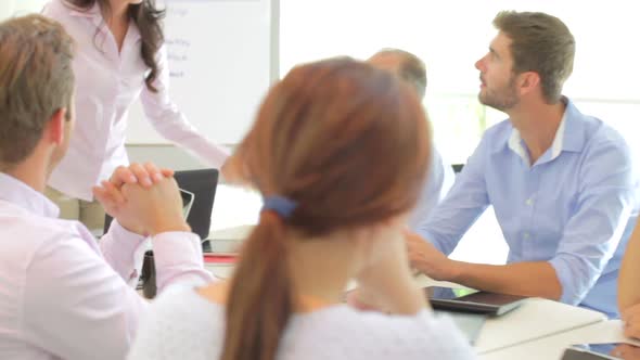 Businesswoman Addressing Meeting Around Boardroom Table 2