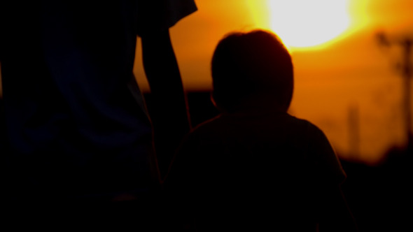 Family Walking At Sunset