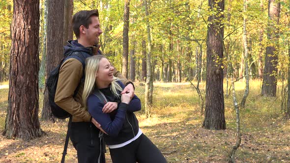 A Hiking Couple Dances in a Forest