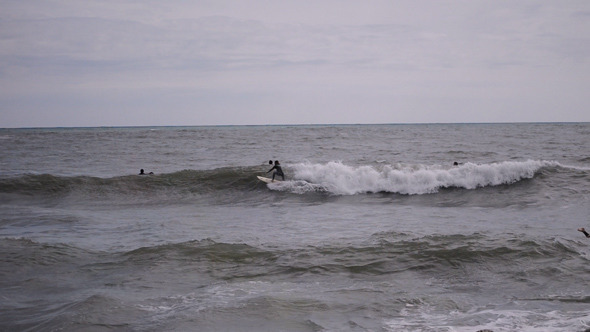 Surfer Catches A Wave