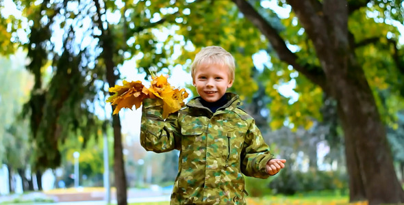 Happy Child Playing in Autumn Park