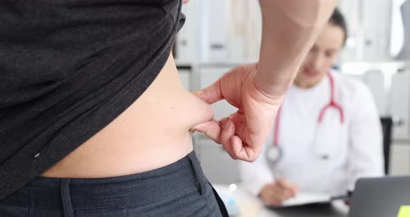 Patient Shows Excess Weight and Fat Folds on His Side at Medical Appointment with Doctor  Movie