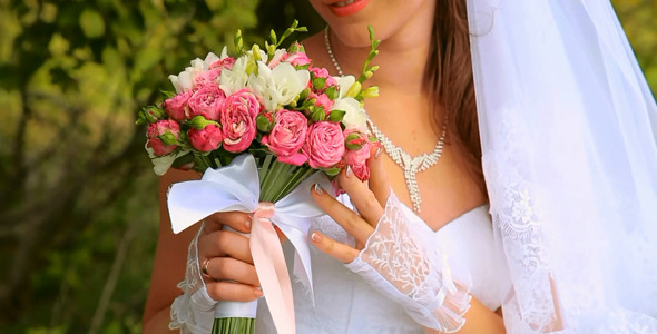 Wedding Bouquet of Flowers in Hands of Young Bride