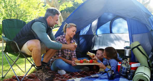 Family having snacks outside the tent