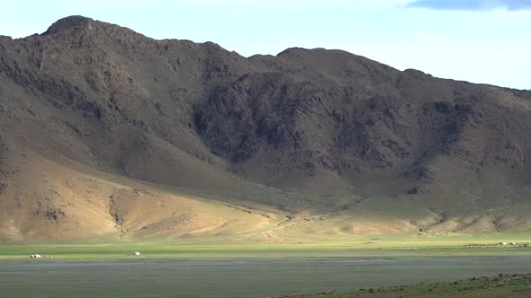 Asian Yurts in Green Plain Beside The Treeless Hill