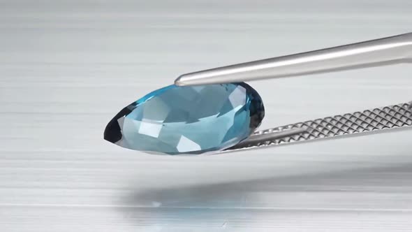 Natural London Blue Topaz Pear Cut in the Turning Tweezers