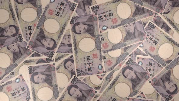 5000 Japanese yen bills background. Many banknotes.