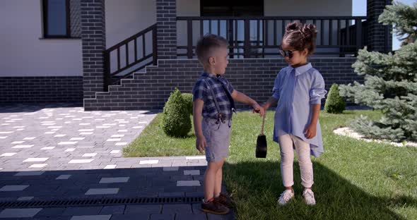 Little Girl And Boy In Summer Clothes Holding Hands. Brother And Sister