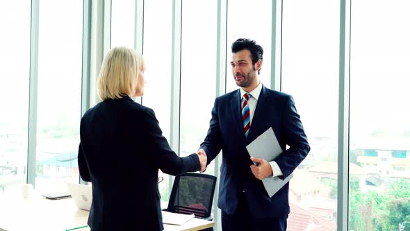 Business People Handshake with Friend at Office