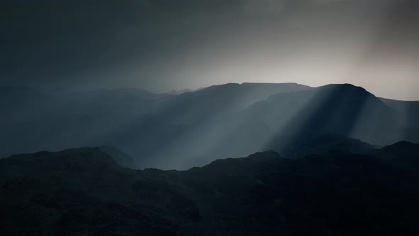 Black Rocky Mountain Silhouette in Deep Fog