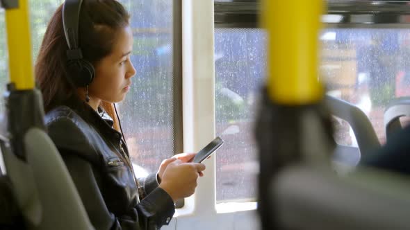 Teenager girl listening to music on headphones 4k