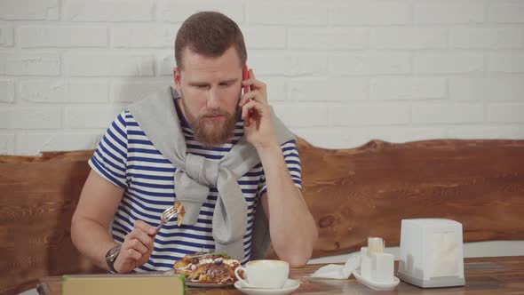 Guy Talking on Phone While in Restaurant.