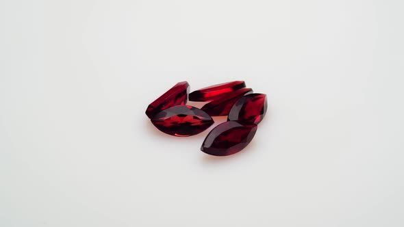 Natural Red Garnet Gemstone on the White Background on the Turning Table