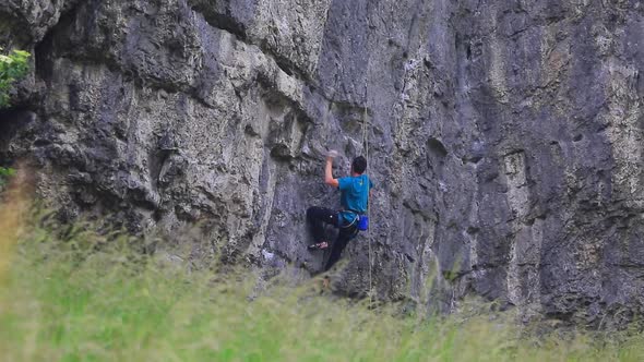 A man rock climbing up a mountain.