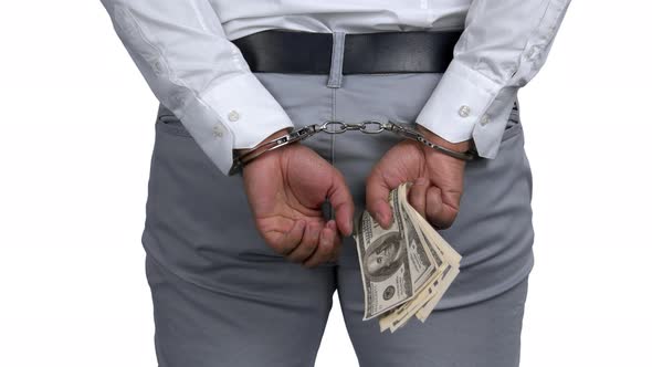 Arrested Man in Handcuffs Holding Money