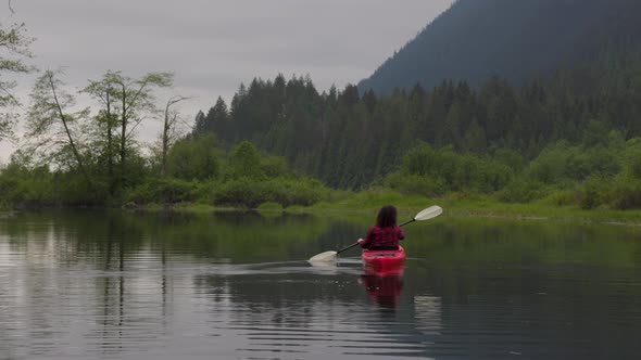 Adventure Caucasian Adult Woman Kayaking in Red Kayak