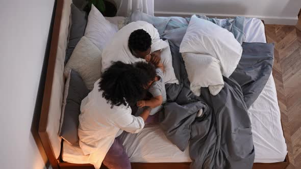 Top View Happy African American Cute Little Boy Laughing As Parents Tickling Child