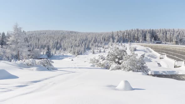 Snowcovered Landscape with a Forest  View From a Slope