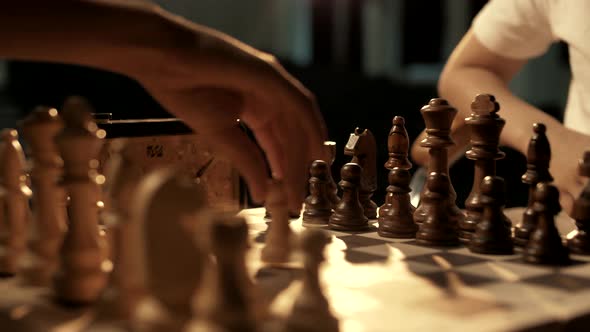 The first move of a pawn in chess. Chess board, close-up. Cinematic