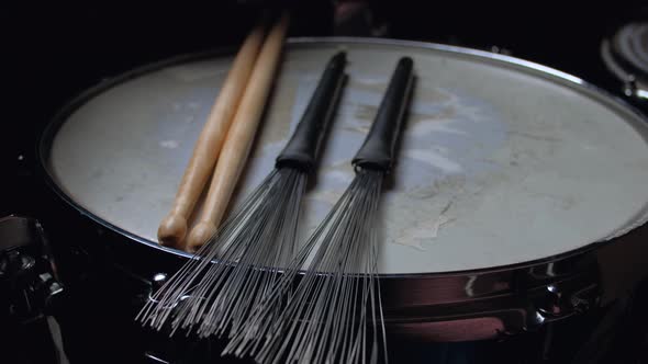 Drumstick and Brushes Lying on a Drum Snare Close Up