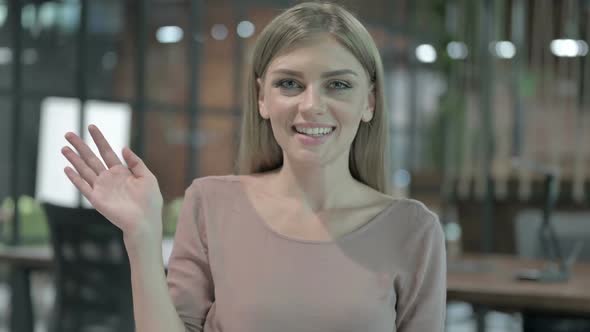 Portrait Shoot of Cheerful Woman Waving and Smiling