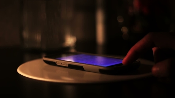 Hand Typing On a Smartphone In The Dark