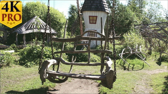 A Wooden Swing on the Houses Backyard